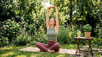 Woman stretching by window in morning light