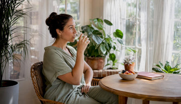 Woman enjoying gentle morning sunlight indoors