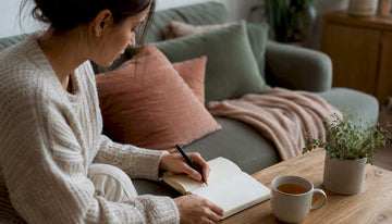 Woman writing weekly wellness journal
