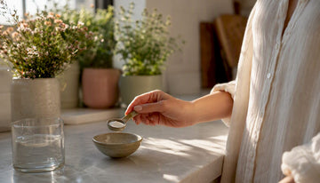 Hand holding insulin vial on warm wellness counter