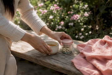 Hands arranging wellness items on nightstand