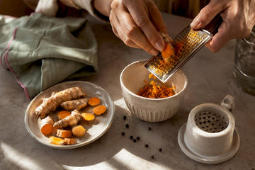 Hands preparing fresh turmeric tea