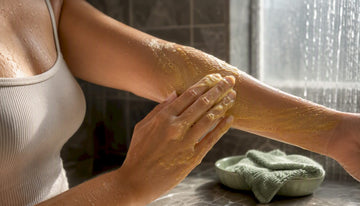 Woman applying turmeric body wash lather