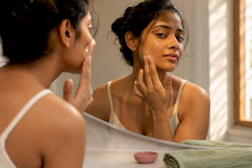Woman applying treatment to hormonal acne