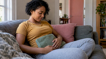 Woman resting with a heating pad