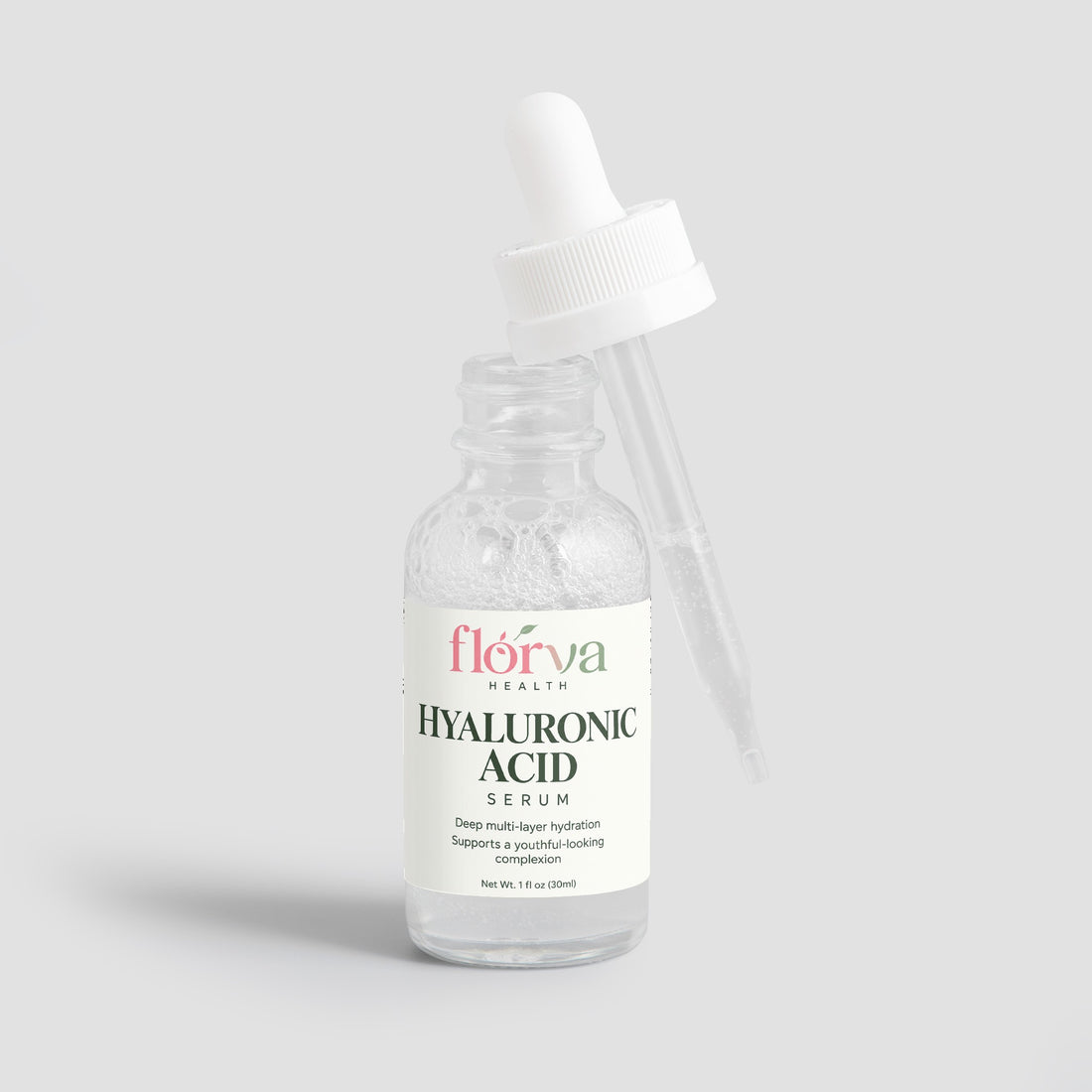 A clear glass dropper bottle of Florva Health Hyaluronic Acid Serum with a white cap and white label, set against a plain white background.