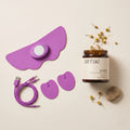 Arrae bloat product with purple electronic device and cable on a beige background